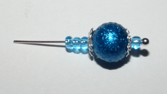 Pin with a blue bead and seed beads for an earring