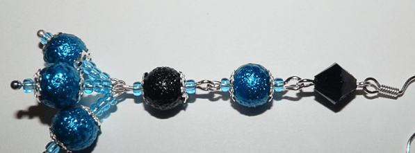 Detail of an earring with blue and black beads