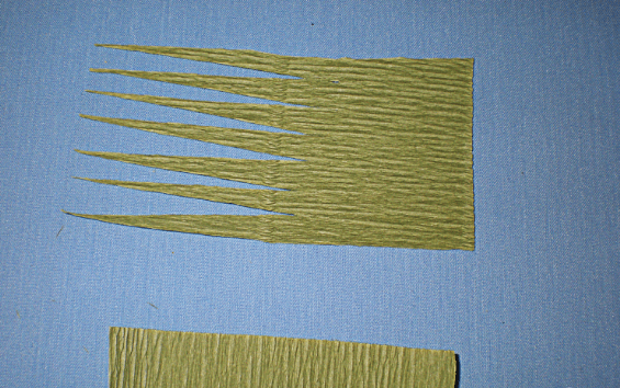 Green strip of paper with notches for a sepal