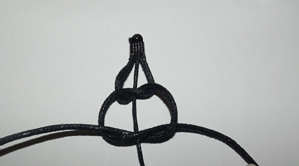 Detail of cords arranged for braiding and a tied knot.