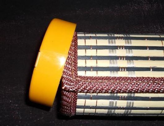 Rolled bamboo placemat inserted into a jar lid to mark required length