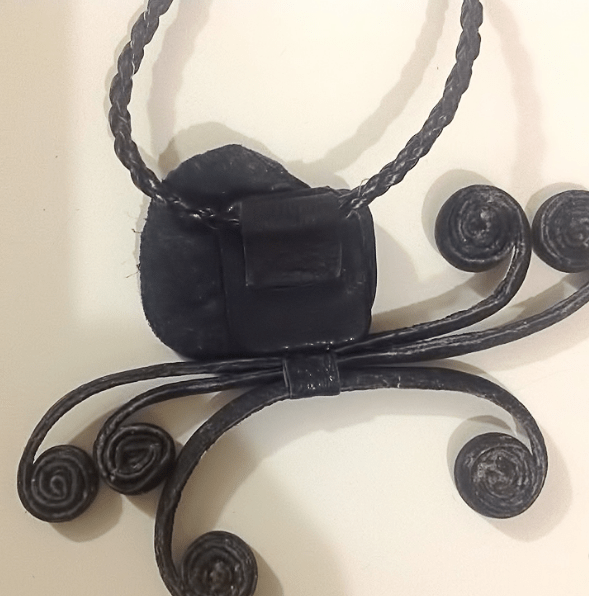 Leather necklace or pendant with decorative curls
