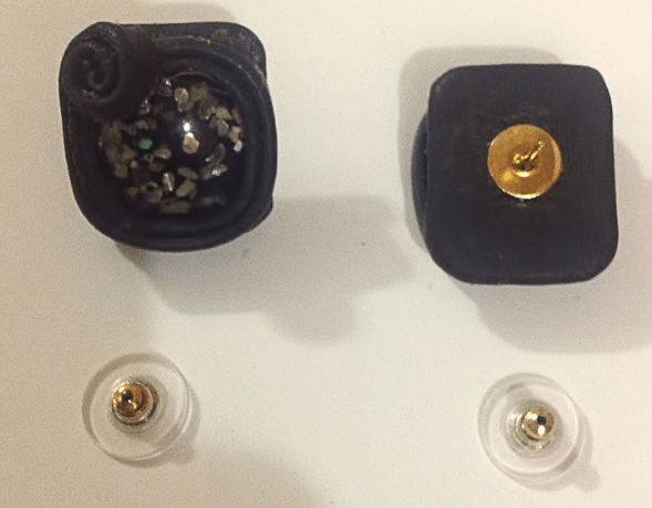 Front and back of a square leather jewelry piece