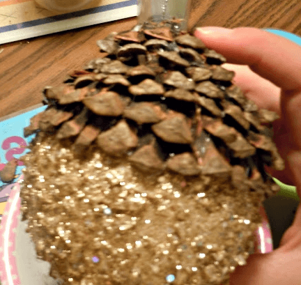 Новогодняя игрушка: Round ornament covered with pine-cone scales