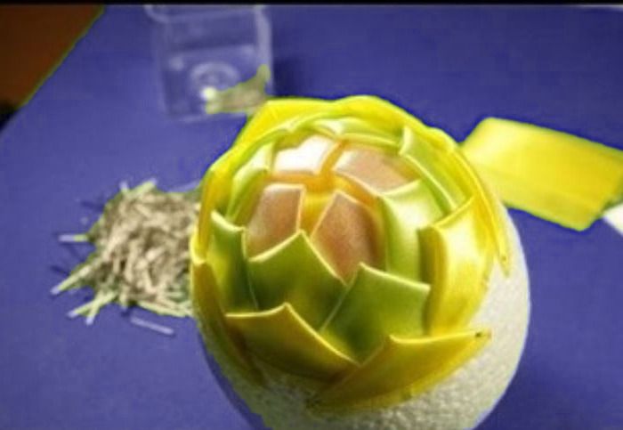 Pinecone base almost fully covered with yellow and green scales