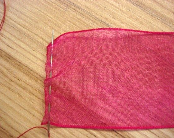 Running stitch along the short cut edge of an organza ribbon