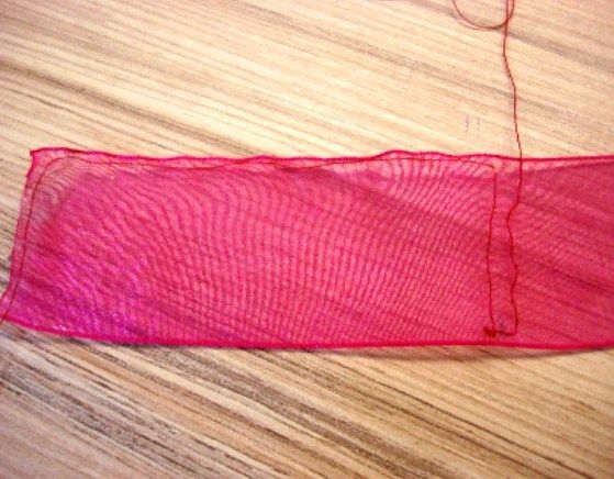 Running stitches along an organza ribbon to form petals