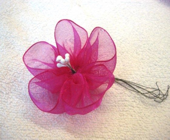 White stamens inserted into the center of an organza flower