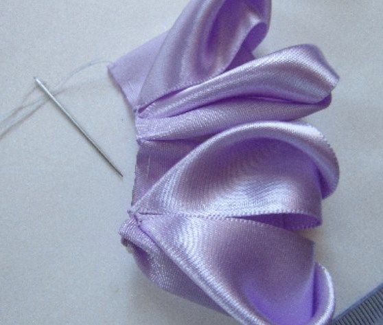 Half of the bow gathered on thread made from lilac petals