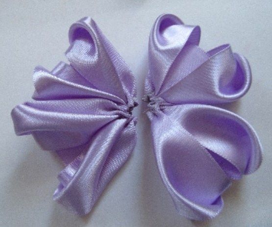 Two gathered halves of a lilac bow