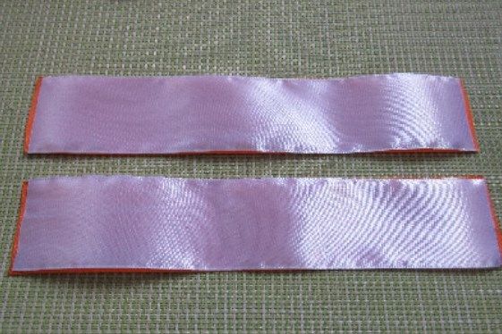 Two pieces of pink and orange satin ribbon