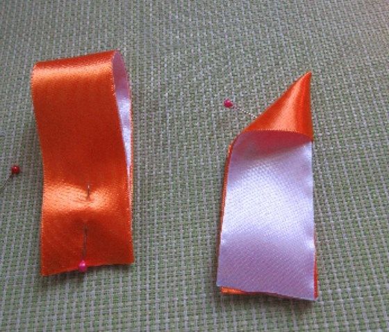 Two folded pieces of satin ribbon for the bow