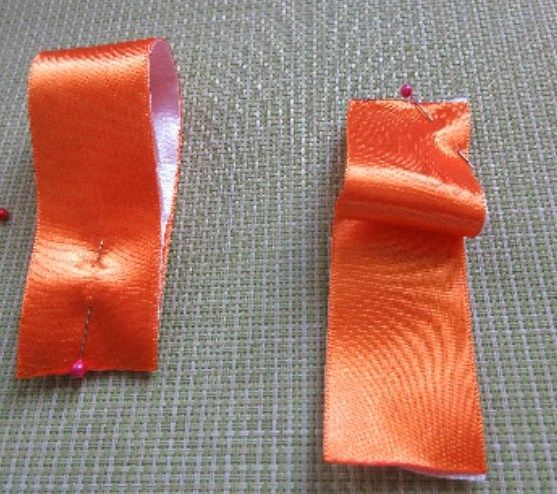 Folded end of two-tone satin ribbon with an angled fold