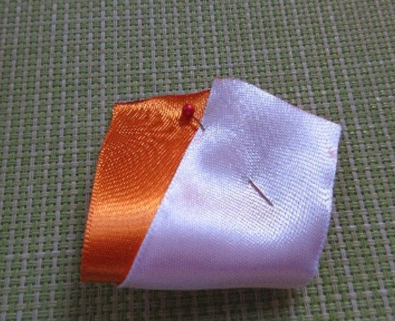 Two-tone satin ribbon piece secured with pins