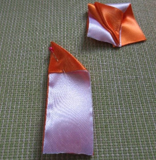 First fold of two-tone satin ribbon for a petal