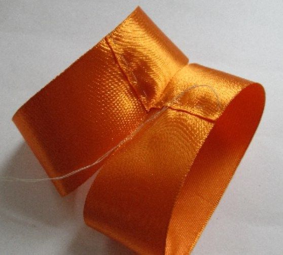 Orange ribbon joined into a ring-shaped piece