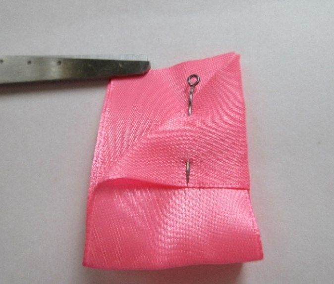 Folded satin ribbon bow piece before assembly