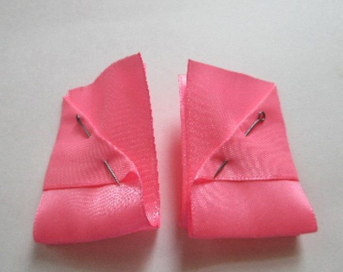Two halves of a satin ribbon bow side by side