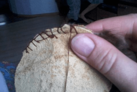 Sewing the legs onto the toy spider's base