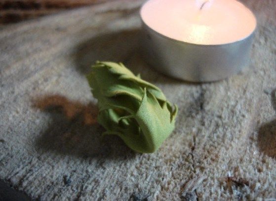 Twisted foamiran bud near a candle