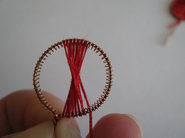 Wire poppy petal filled with red thread