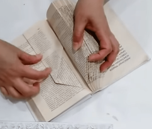 Folding the side of a book page vertically