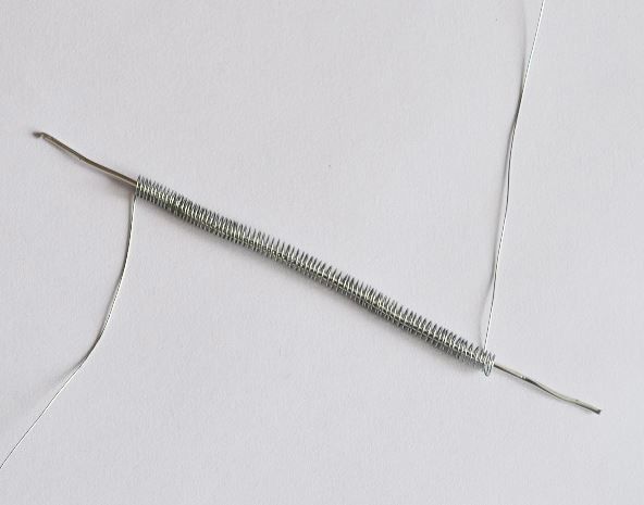 Removing the wire spring from the knitting needle and stretching it