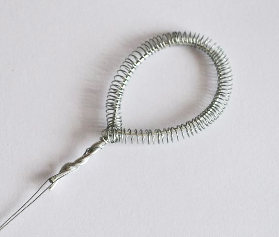 Bending the wire spring into an oval petal shape