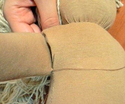 Sewing the arm to the body of a Waldorf doll
