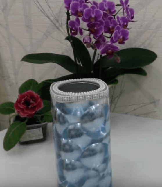 Finished vase made from a jar with raised blue decor and beads