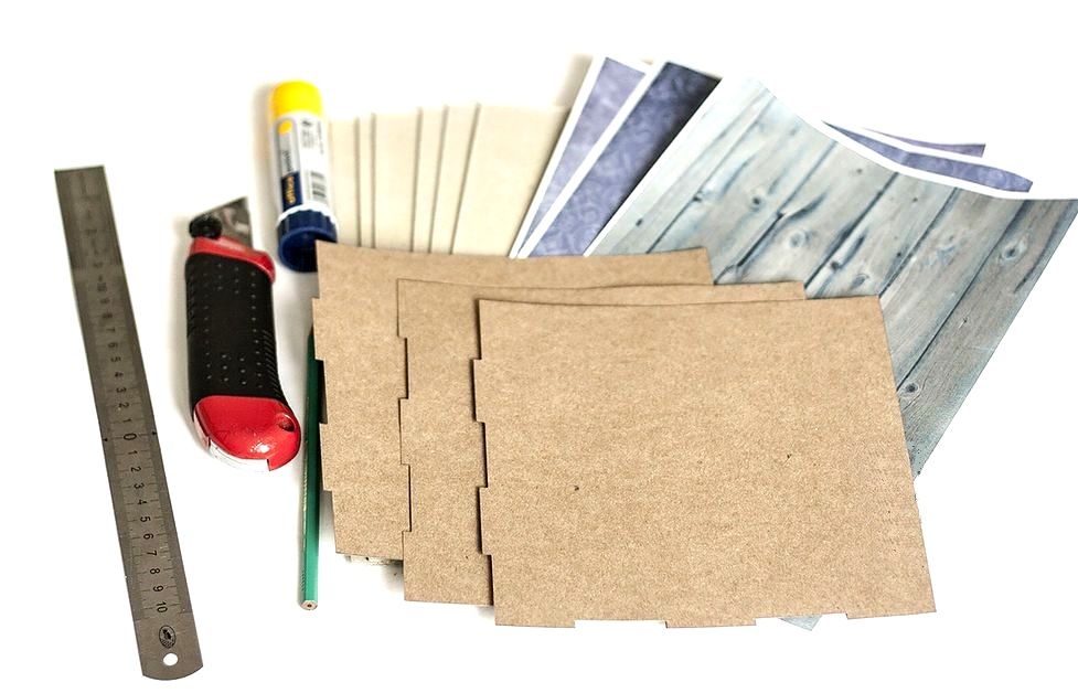 Cardboard, ruler, craft knife, glue, and printed sheets for the photo backdrop