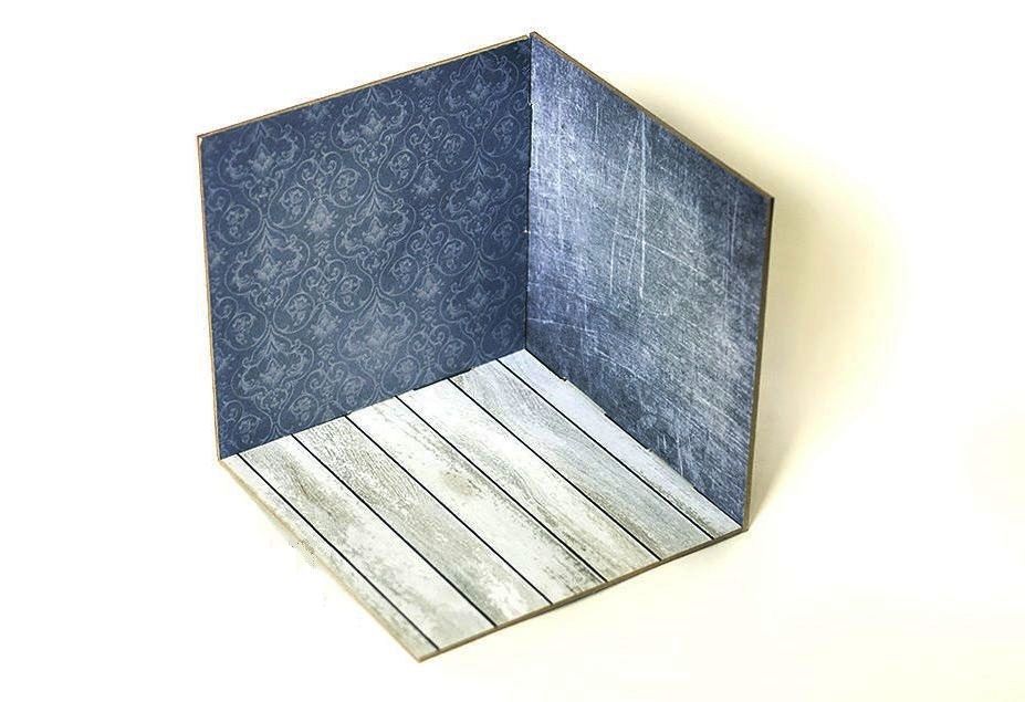 Corner-style 3D photo backdrop with dark walls and a light wood floor