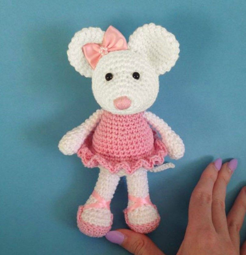 Crochet amigurumi mouse in a pink dress