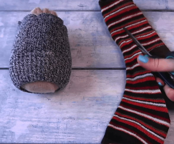 Cutting the striped sock for the gnome's hat