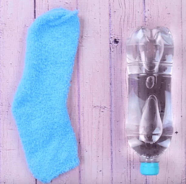 A sock and a plastic bottle for the base of the penguin toy