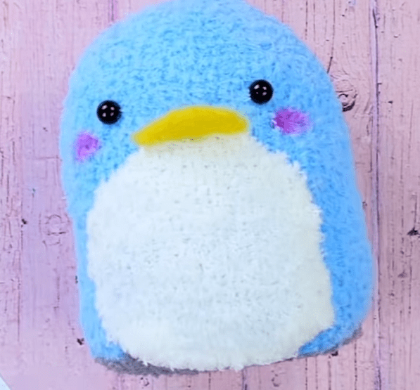 Finished blue sock penguin with a white belly