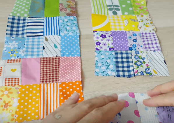 Two patchwork panels made from small rectangles, with a fabric strip for scale