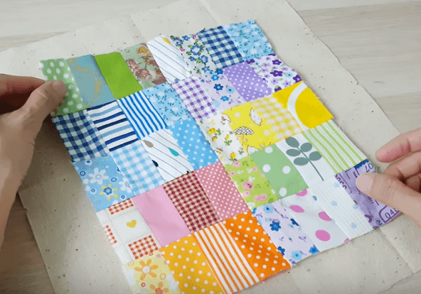 Laying the patchwork panel on the sturdy backing fabric