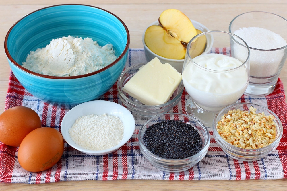 Ingredients for apple muffins: flour, eggs, butter, sour cream, sugar, apples, poppy seeds, candied fruit, and baking powder